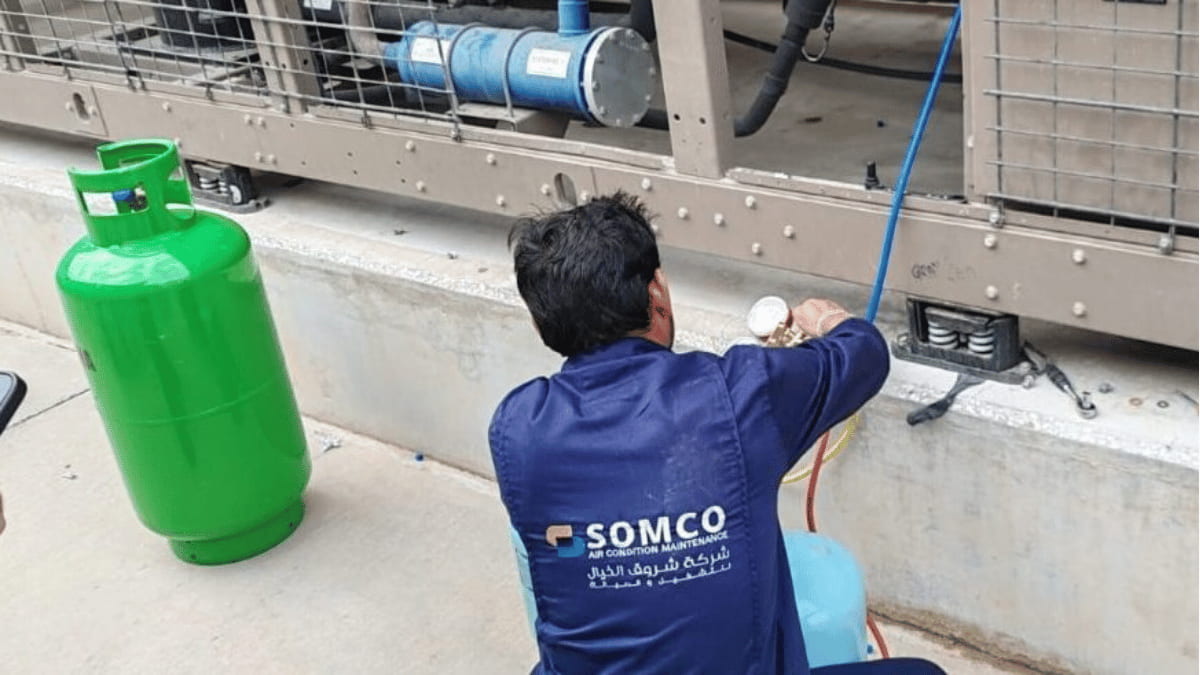 Technician inspecting an air cooled chiller system