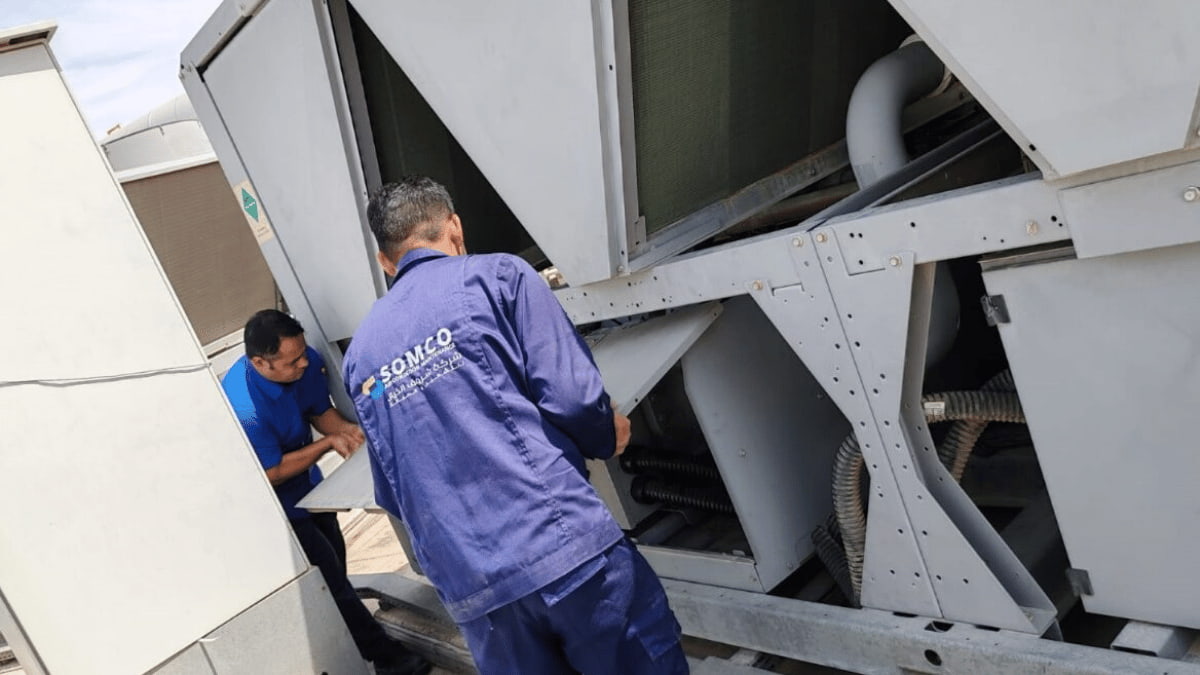 Technicians servicing a commercial chiller system in Dammam