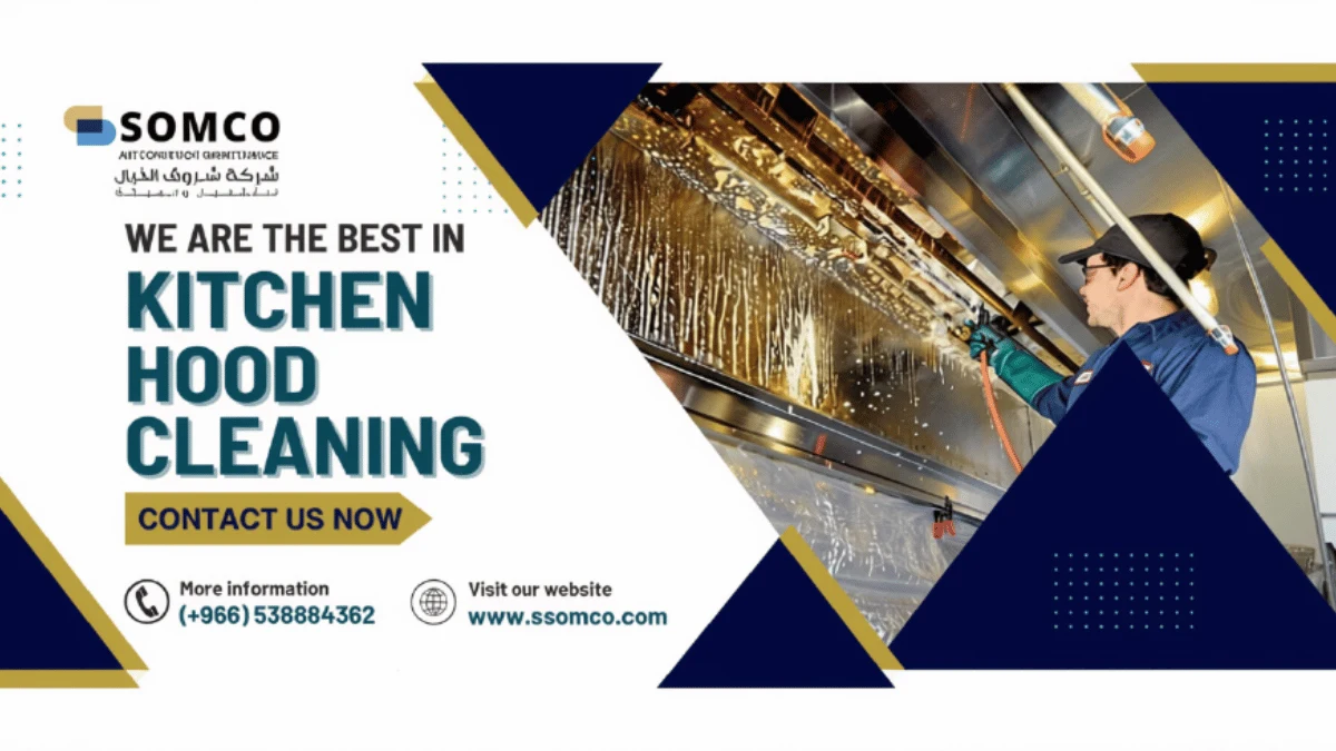 Technician cleaning grease buildup from a commercial kitchen hood